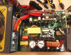 A close-up of a power supply unit with a 24-pin cable connected to a motherboard