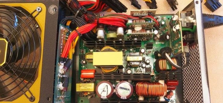 A close-up of a power supply unit with a 24-pin cable connected to a motherboard