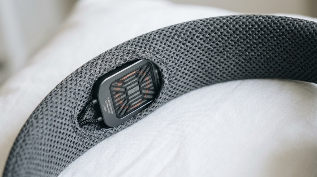 Close up of flat thin speakers inside a breathable mesh headband.